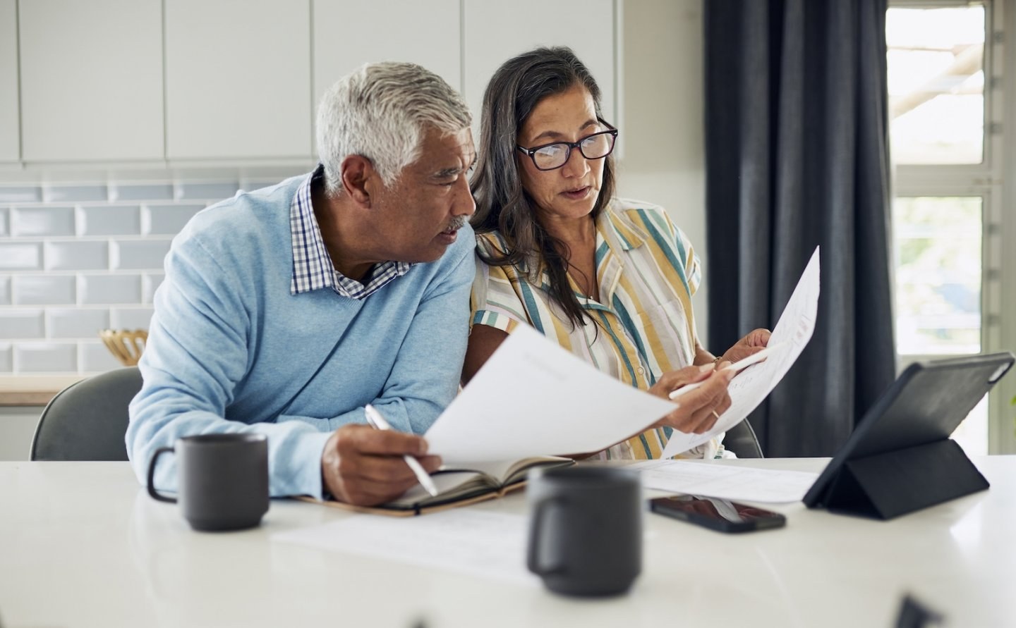 An older couple reviews financial paperwork together