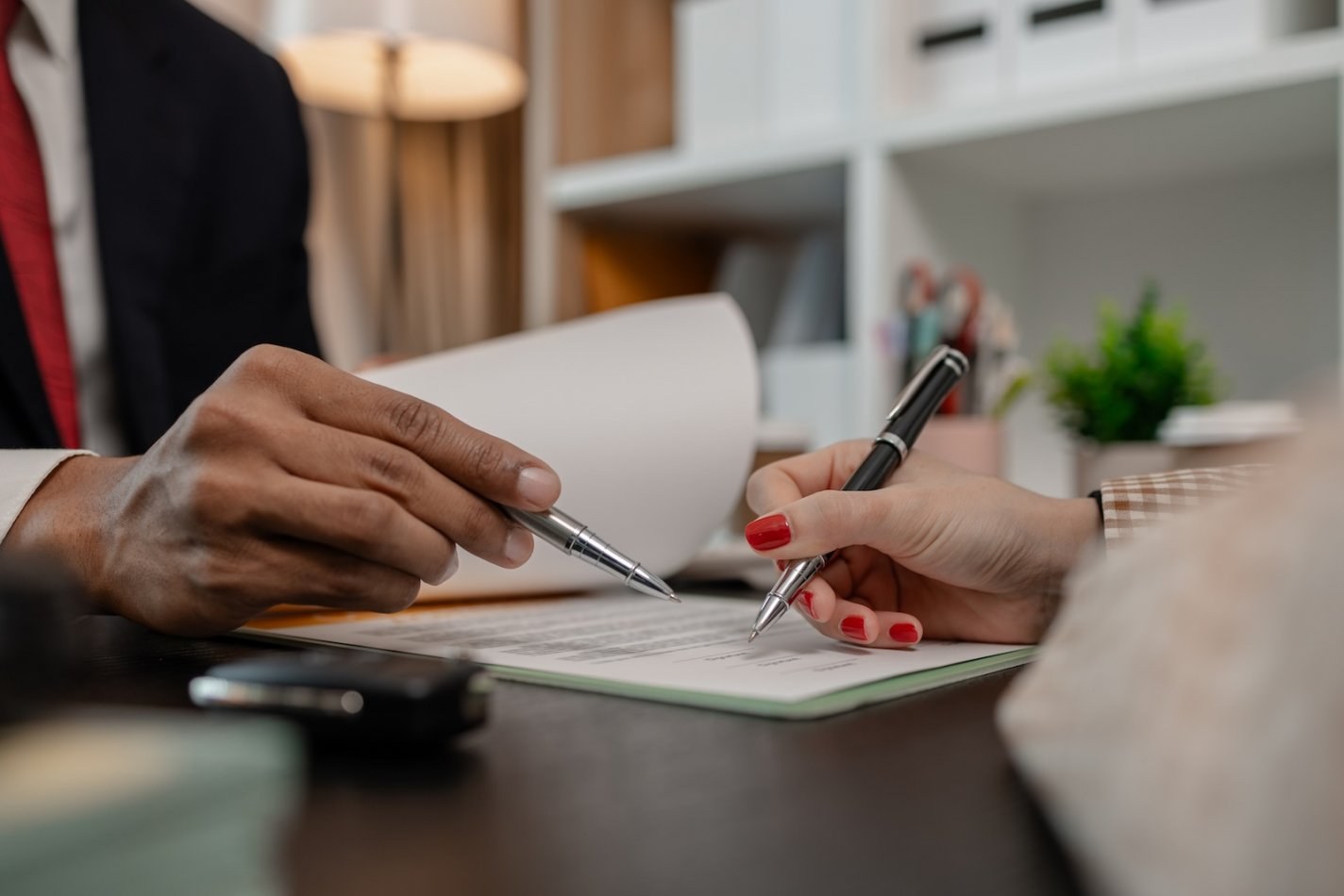 Small business owner signs a service agreement with PEO salesperson