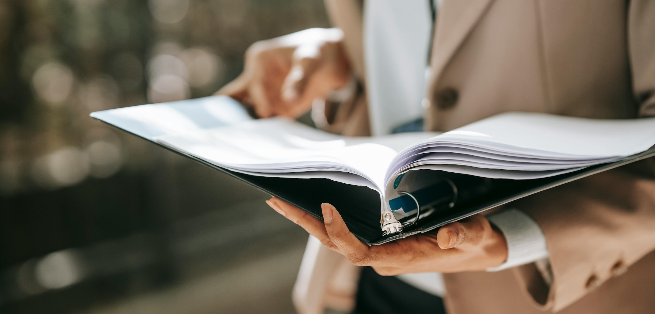 Woman flips through a binder full of papers