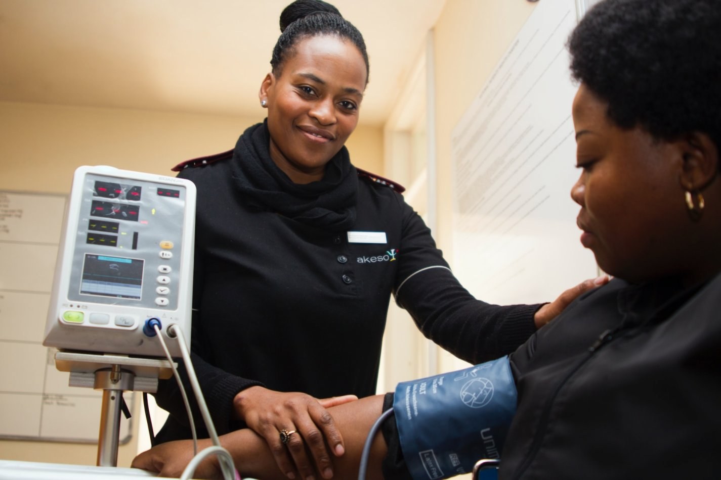 Healthcare worker taking a woman's blood pressure