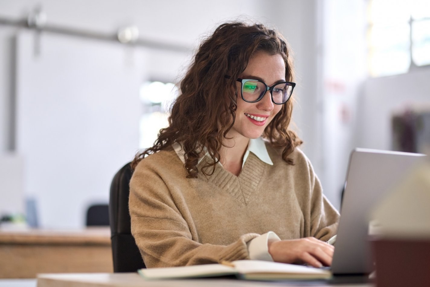 Woman uses her laptop for LMS training at work