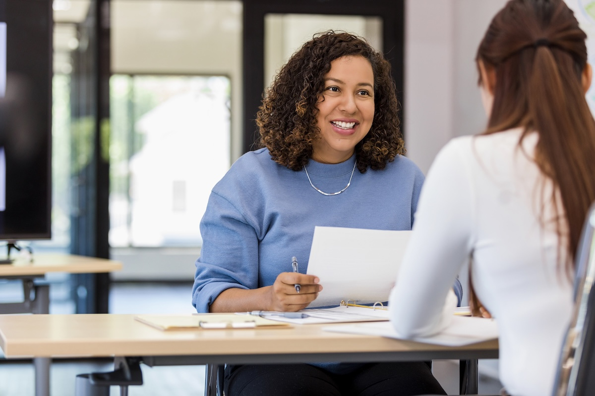 Female boss delivers performance review to employee