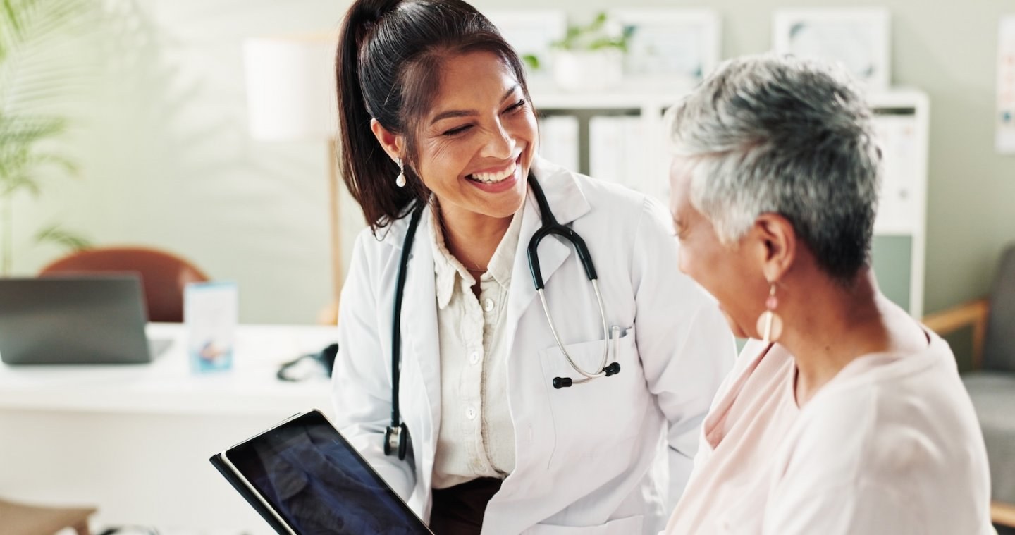 Medical provider meets with patient in a bright office