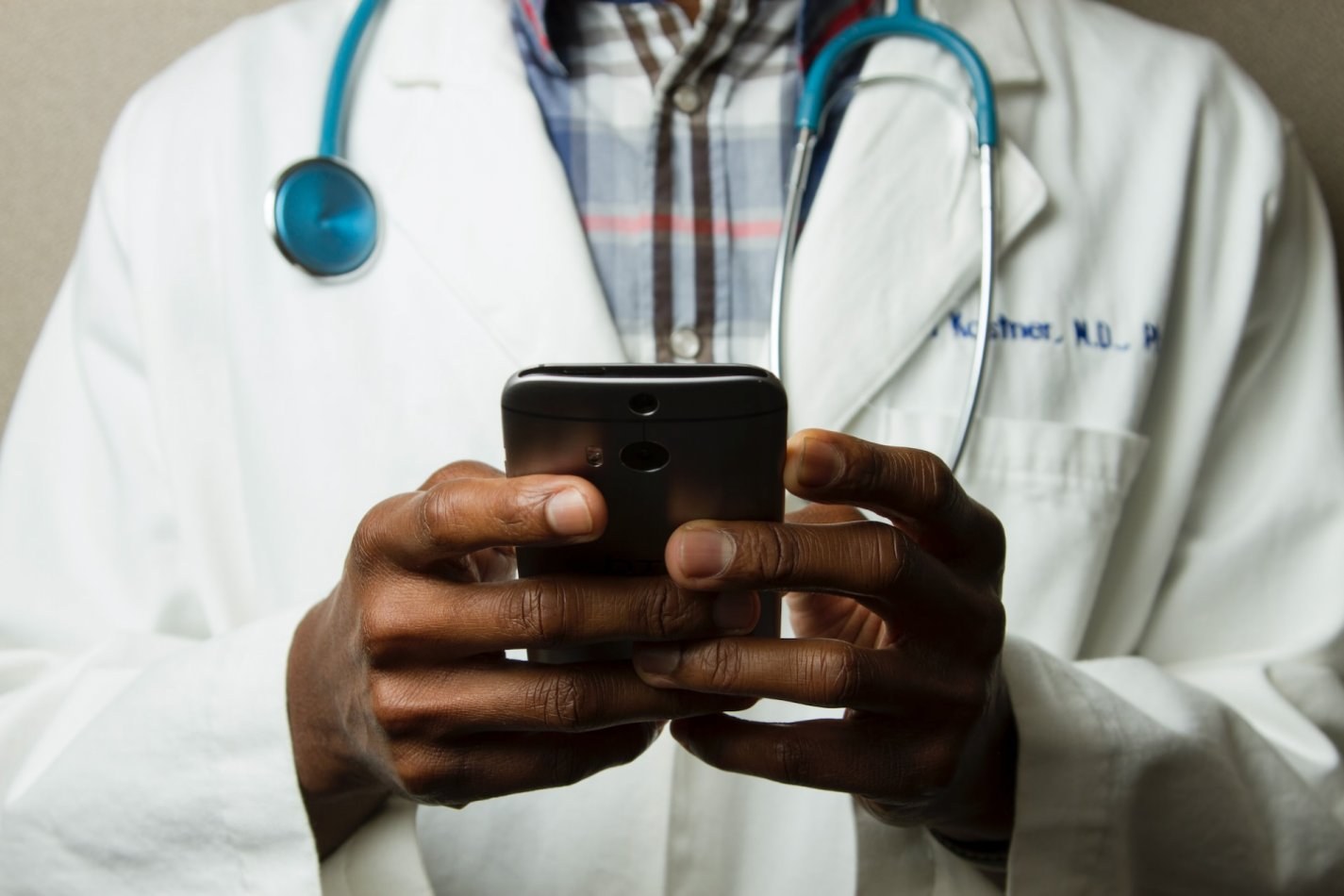 Doctor using a smartphone for a Telehealth visit