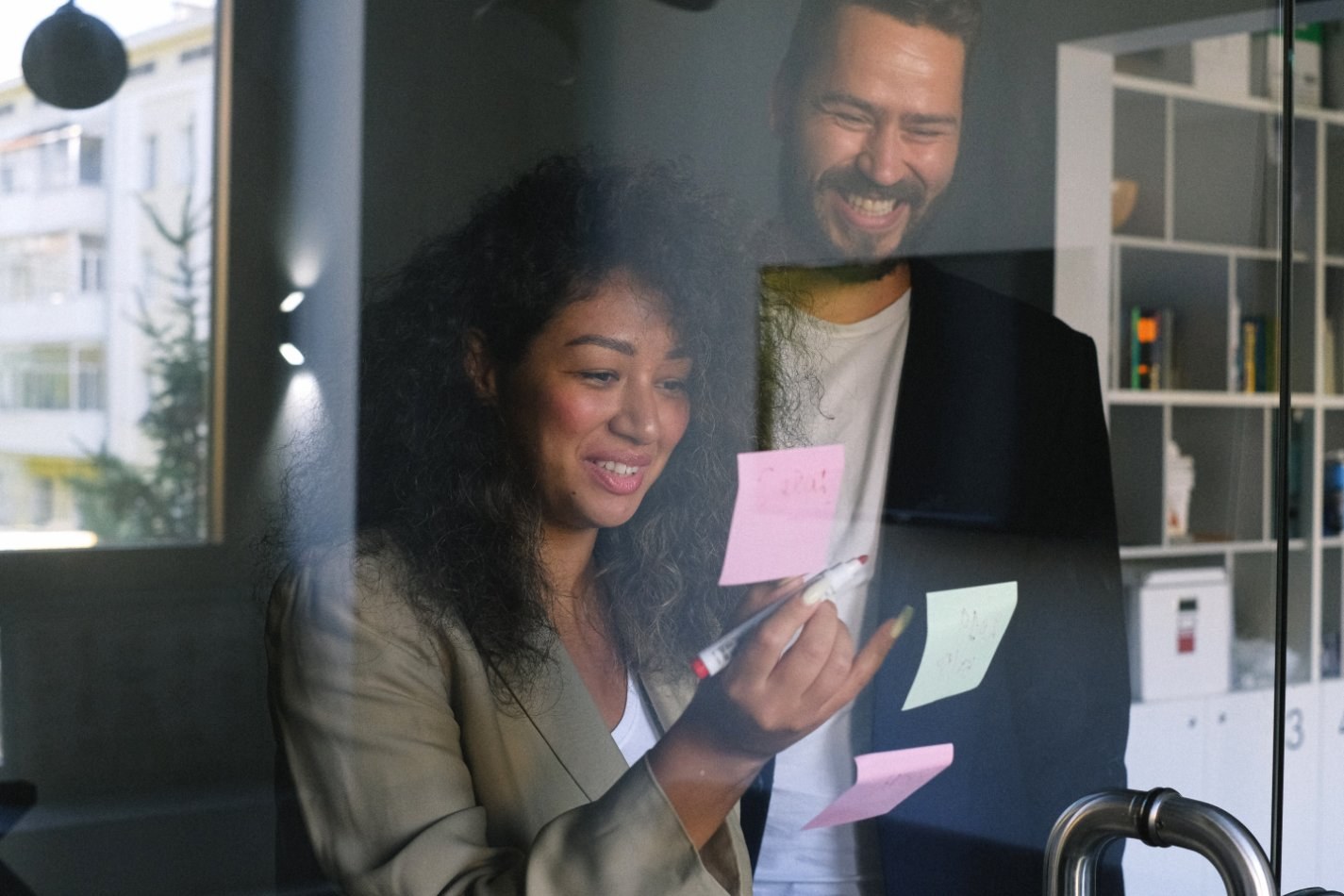 Two people looking at sticky notes