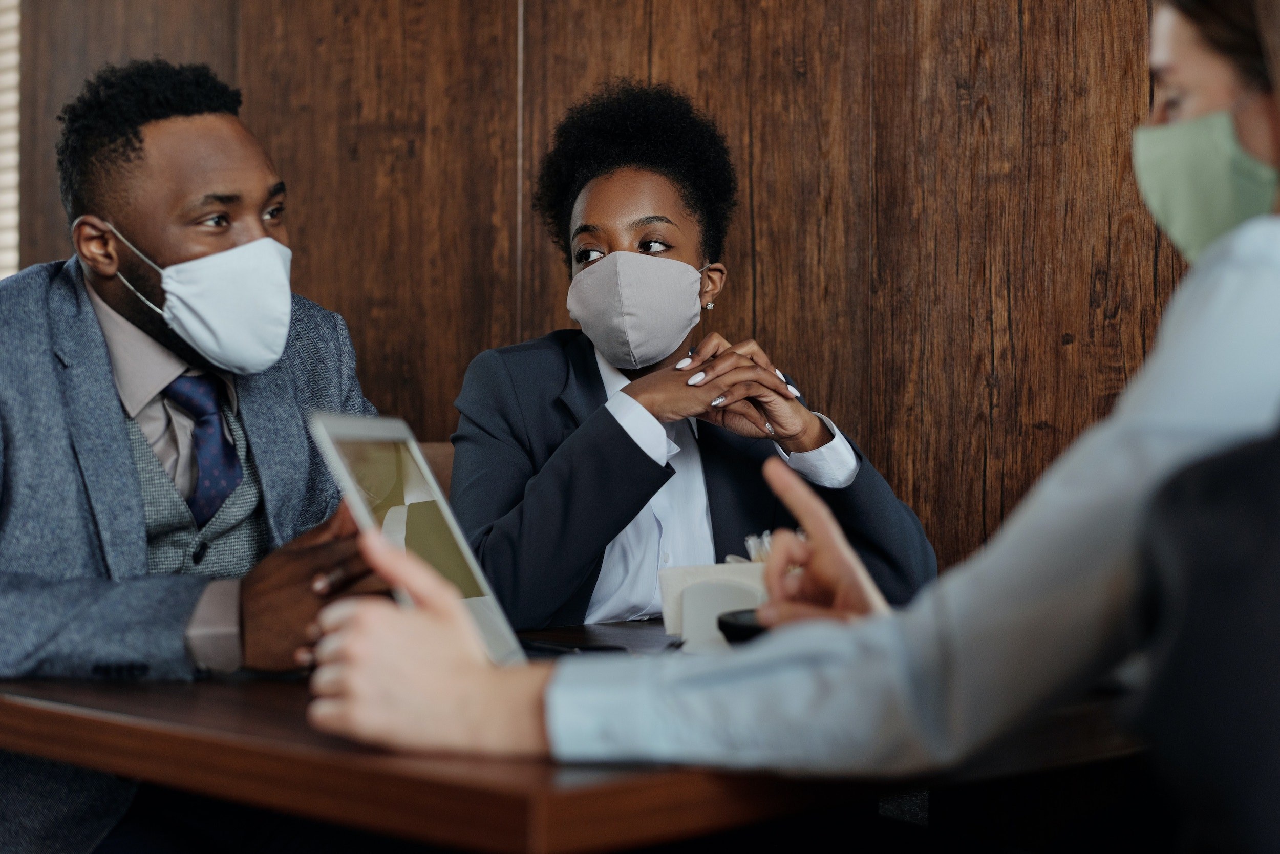 People wearing masks while having a discussion