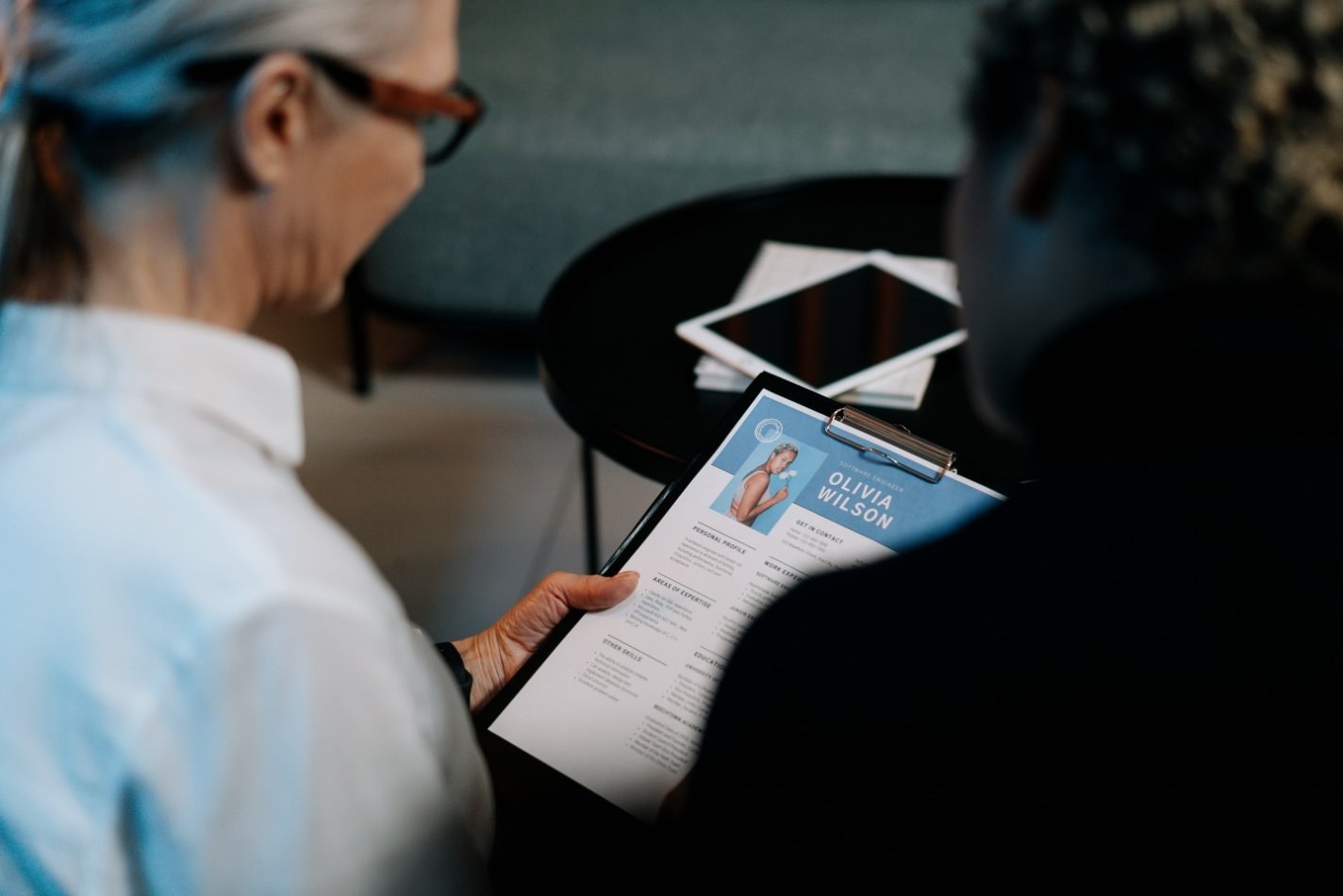 Two people reviewing a resume