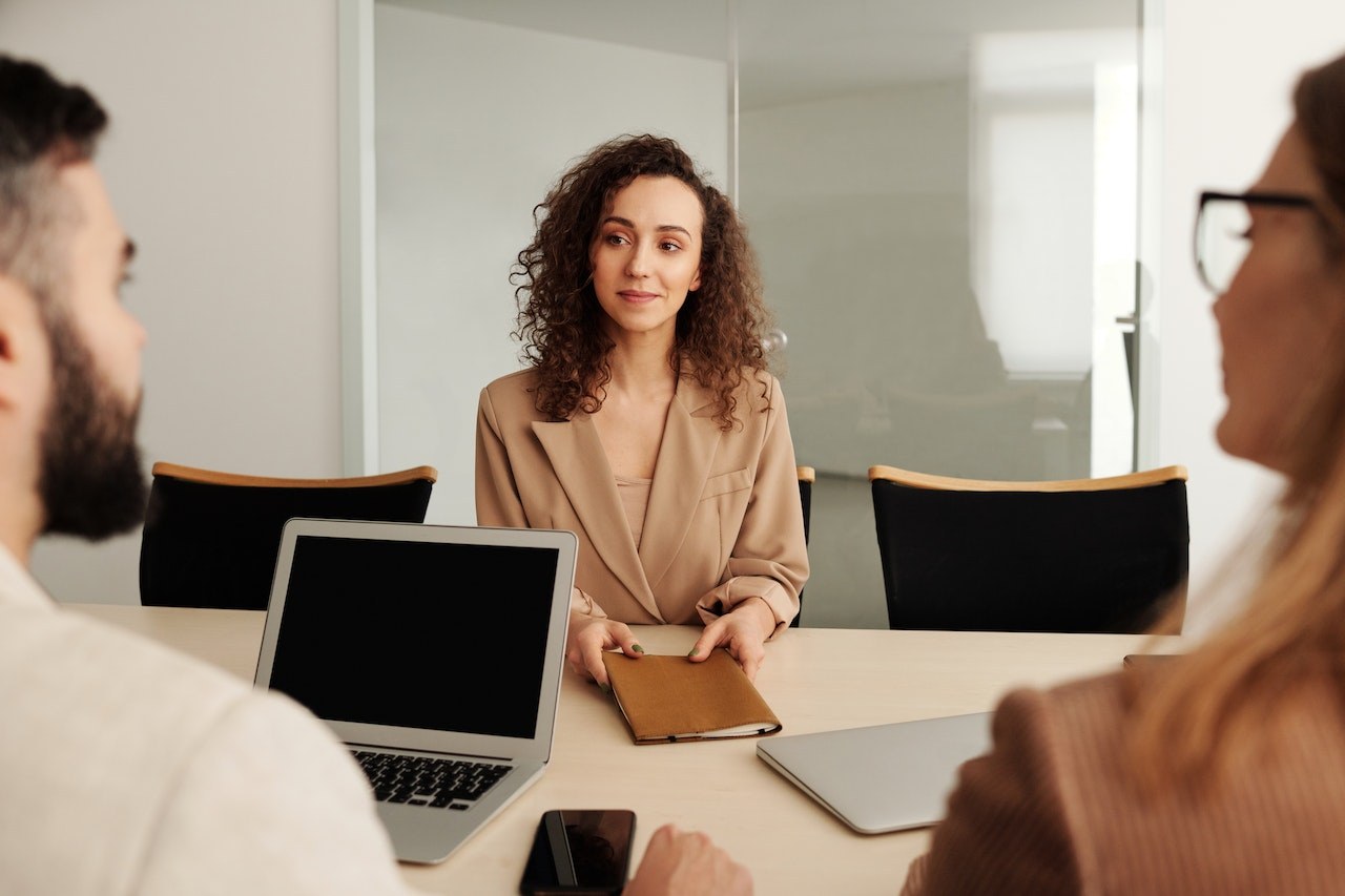 Business meeting or interview between three people