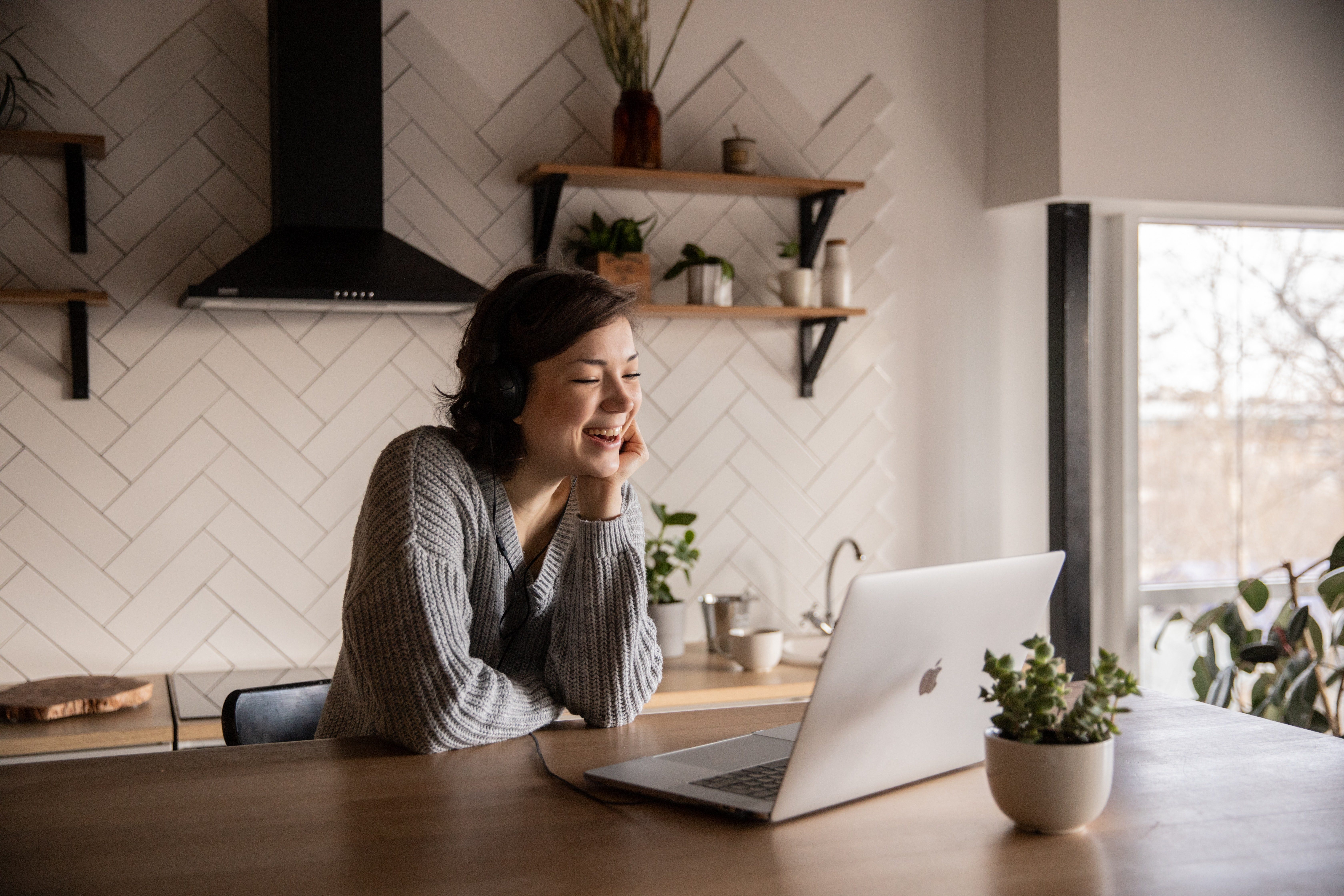 Woman smiling while on a virtual meeting at home