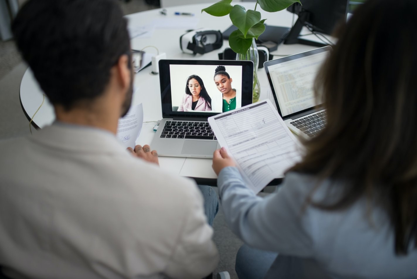 Two people working on a laptop