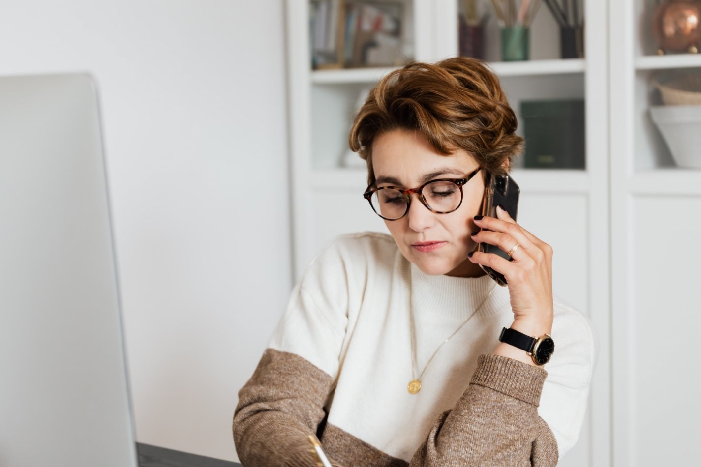 Person taking notes while on the phone