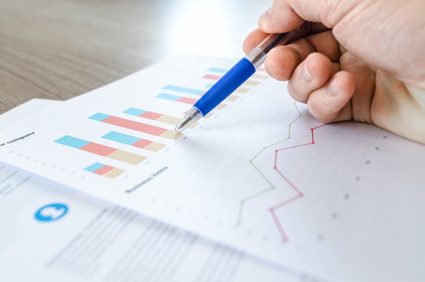 Pen pointing to a graph on paper