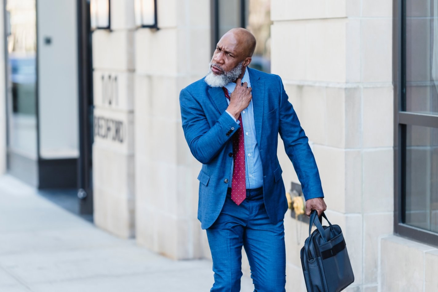 Man in suit walking with a briefcase