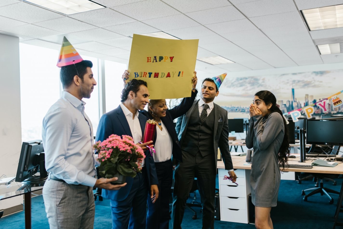 Co workers hosting a surprise birthday party