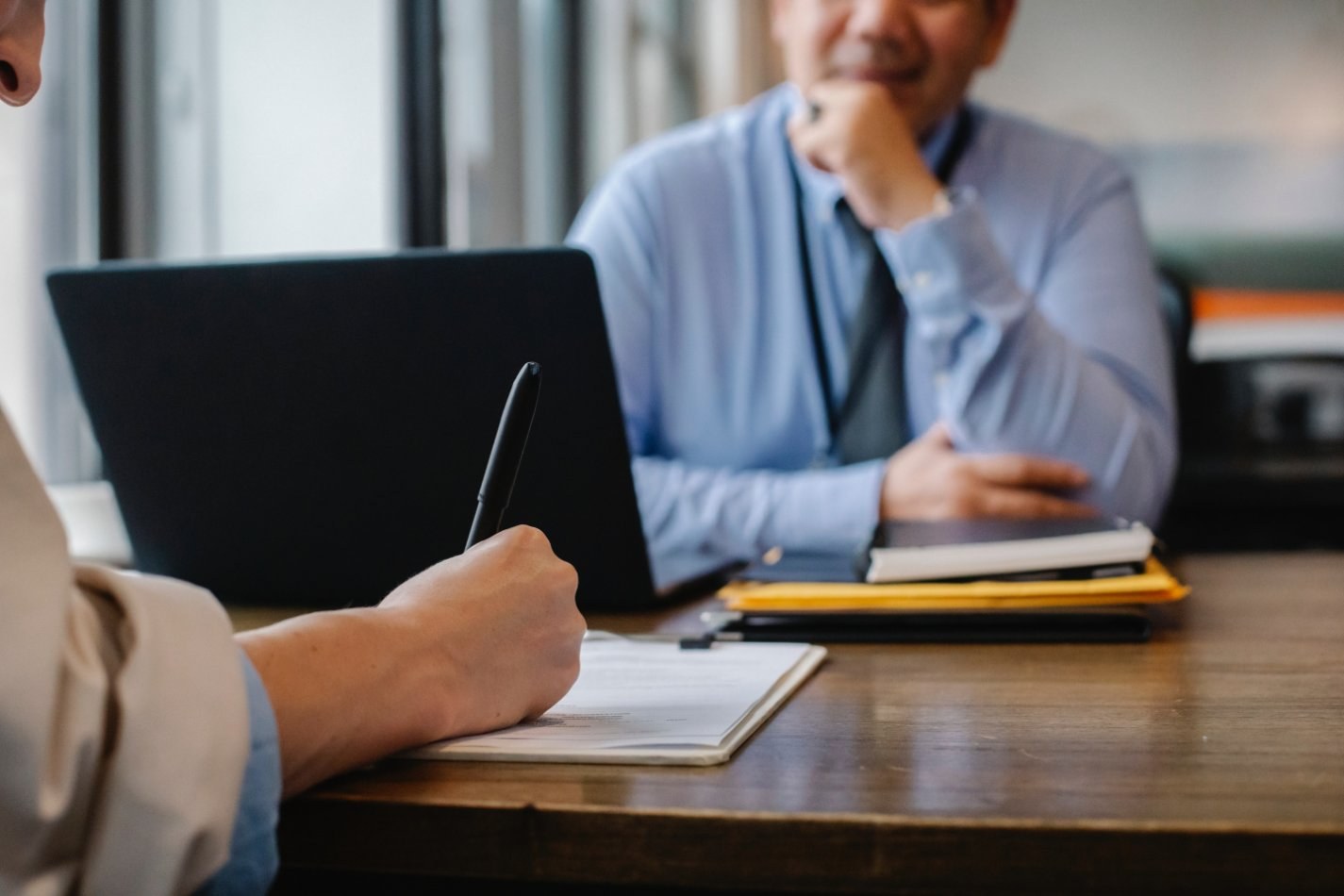 Person taking notes during a conversation