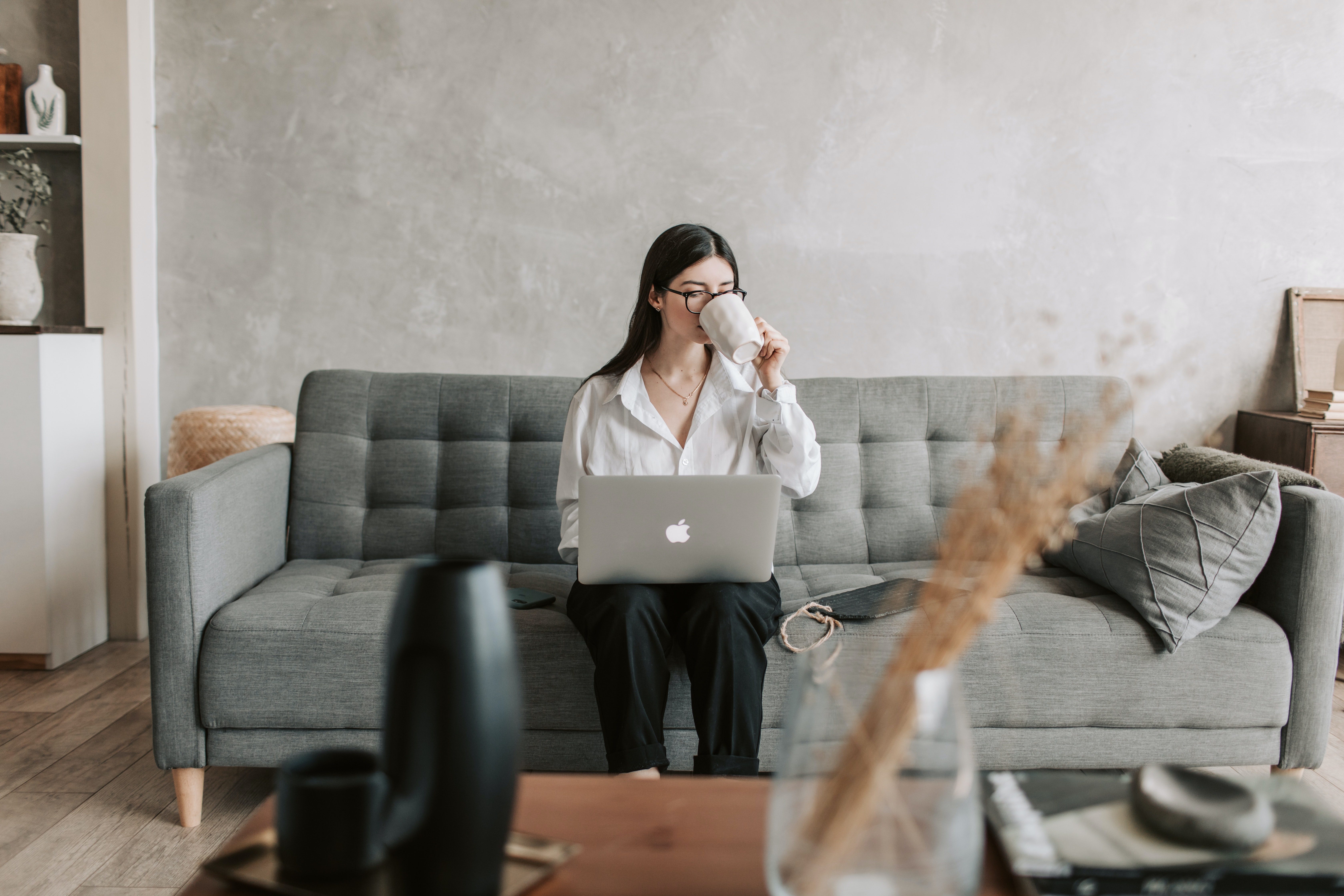 Woman drinking coffee while working from home